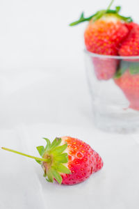 Close-up of strawberries on table against white background