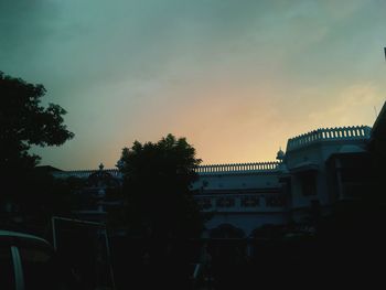 Built structure against sky at sunset