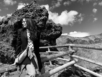 Woman looking at camera against mountains