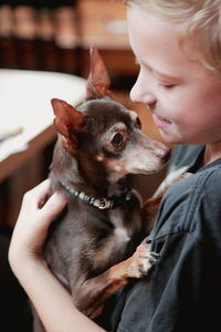 Close-up of young man holding dog