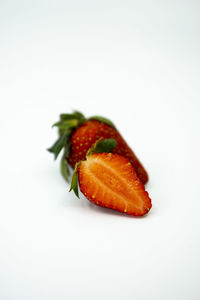 Close-up of strawberries in plate against white background