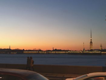 City at waterfront during sunset