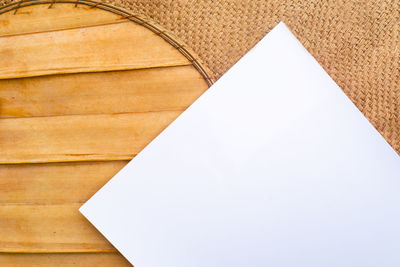 High angle view of paper on table against white wall