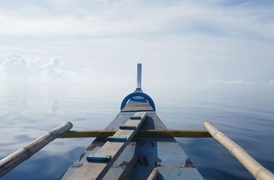 Close-up of boat in sea against sky