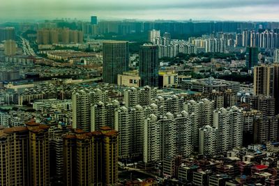 High angle view of modern buildings in city against sky