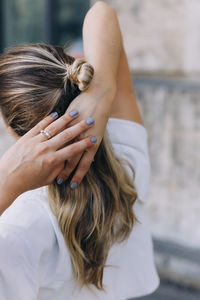 Rear view of woman with hands on hair