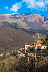 High angle view of houses and mountains against sky