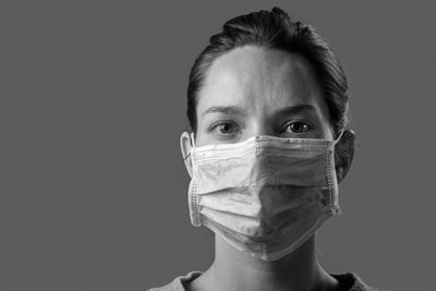 Portrait of teenage girl against gray background