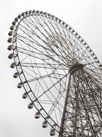 Low angle view of ferris wheel against sky