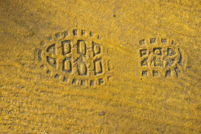 Walkers boot print in yellow asphalt