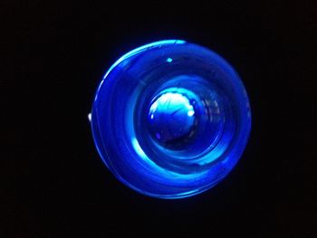 Close-up of blue object over black background