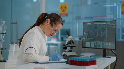 Side view of doctor working at table