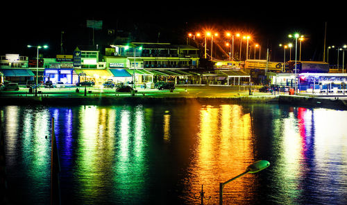 Illuminated boats in water at night