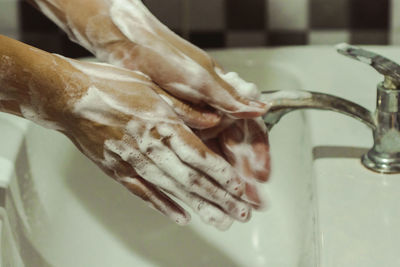 Close-up of hand in bathroom