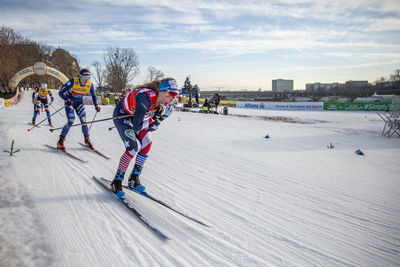 People walking on snowy field during winter