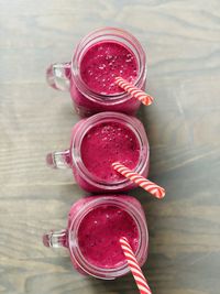 High angle view of red drink in glass jar on table