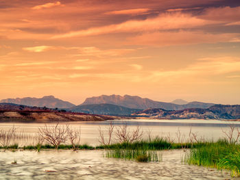 Scenic view of lake against sky during sunset