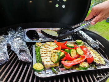 High angle view of person preparing food on barbecue grill