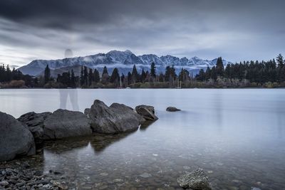 Scenic view of lake and mountains against sky