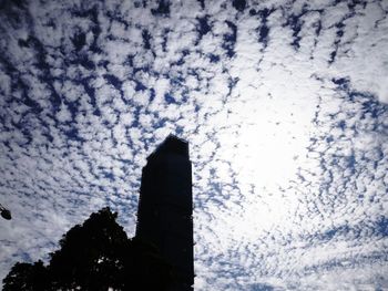 Low angle view of building against cloudy sky