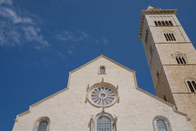 Low angle view of historic church and tower against sky