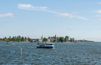 Ship sailing on sea against sky