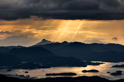 Scenic view of silhouette mountains against sky during sunset