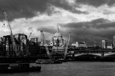 Bridge over river against buildings in city of london
