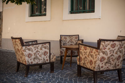 Empty chairs and table in building