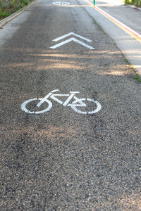 High angle view of arrow sign on road