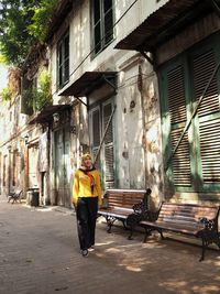 Full length of man standing on street against building