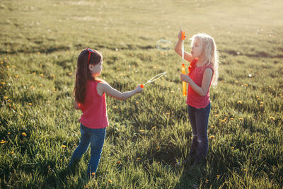 Girls playing with bubble wand