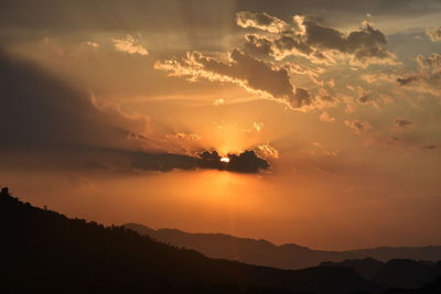 Scenic view of silhouette mountains against sky during sunset