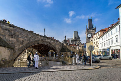 Street scene amidst charles bridge and residential buildings against sky