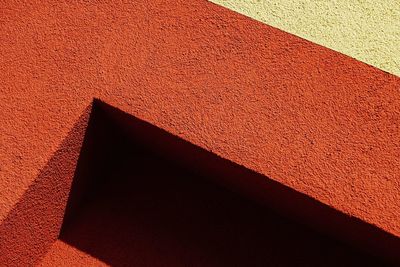 High angle view of red shadow on wall