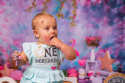 Portrait of cute messy girl eating cake 