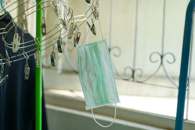 Close-up of blue glass hanging on clothesline