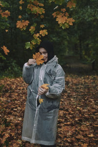 Rear view of woman standing against plants