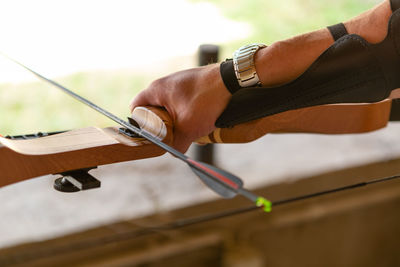 Cropped hand of man working at workshop