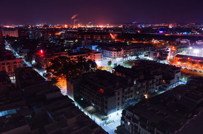 Illuminated cityscape against sky at night