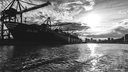 Commercial dock by sea against sky