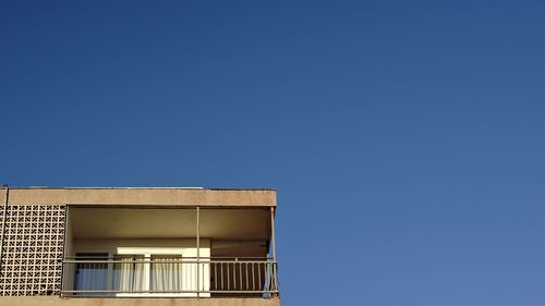 Low angle view of building against clear blue sky