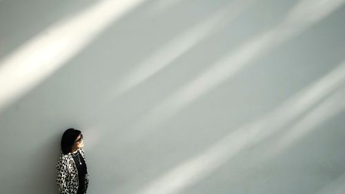 Woman standing against wall