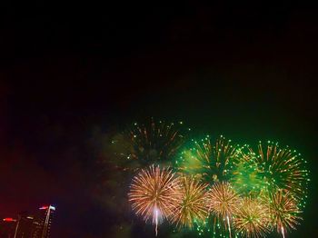 Low angle view of firework display at night