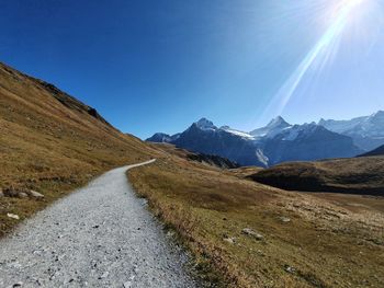 Scenic view of snowcapped mountains against clear blue sky