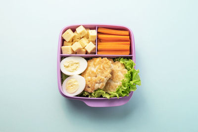 High angle view of food on plate against white background