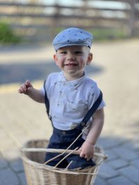 Portrait of smiling boy holding camera