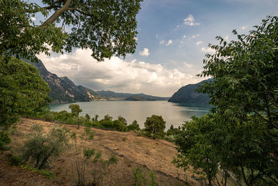 Scenic view of lake and mountains against sky