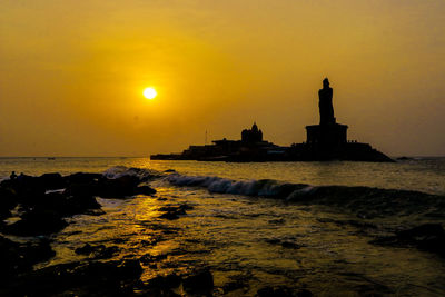 Scenic view of sea against orange sky