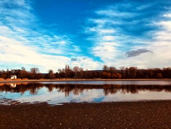 Scenic view of lake against blue sky